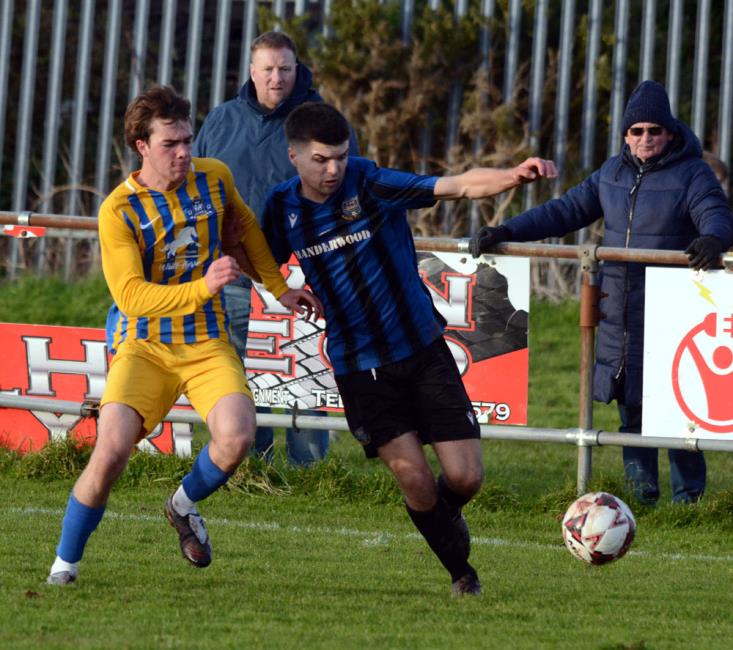 Camron Thomas battles for possession